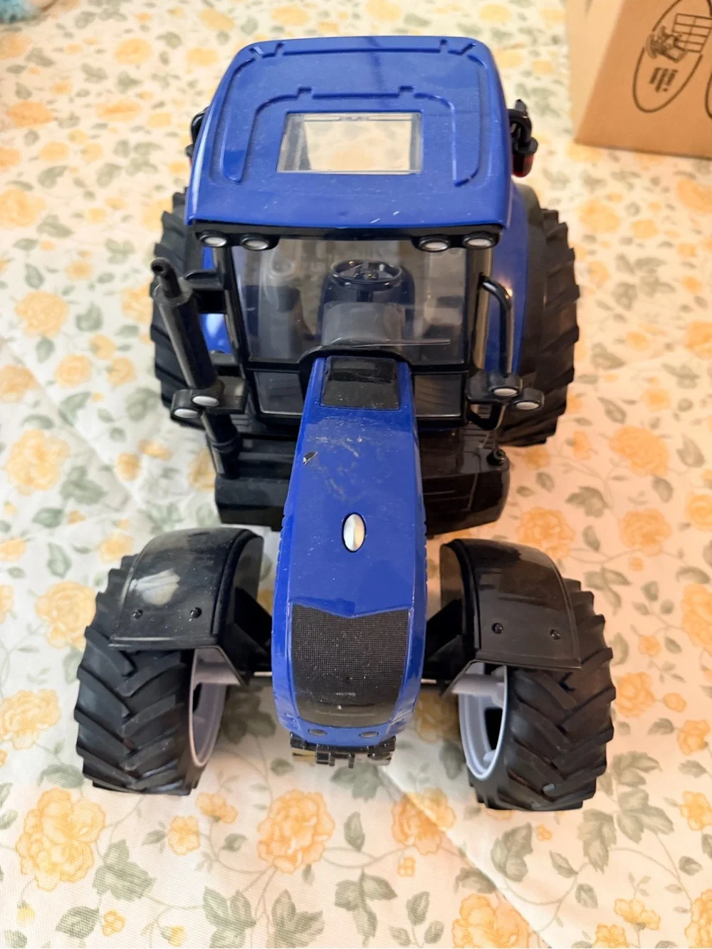 Medium plastic blue and black electronic toy tractor, lights up with sound